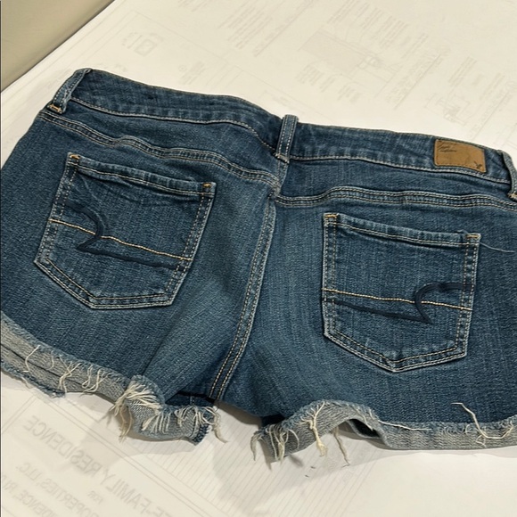 American Eagle Blue Cut-Off Jean Shorts with Frayed Hem and Distressed Details - Picture 2 of 4